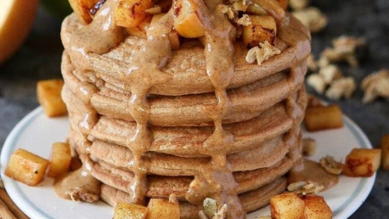 stack of vegan and gluten free pancakes with fruit and nuts topping