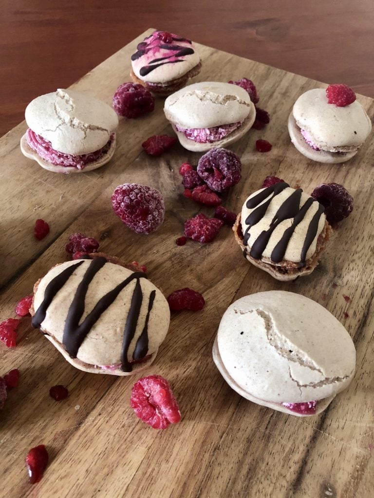 vegan acai macarons on a wooden surface