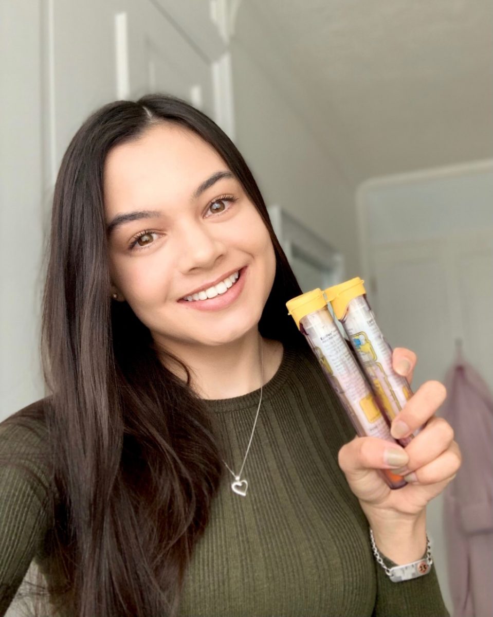 Hannah from @letstalkfoodallergies folding two epipens