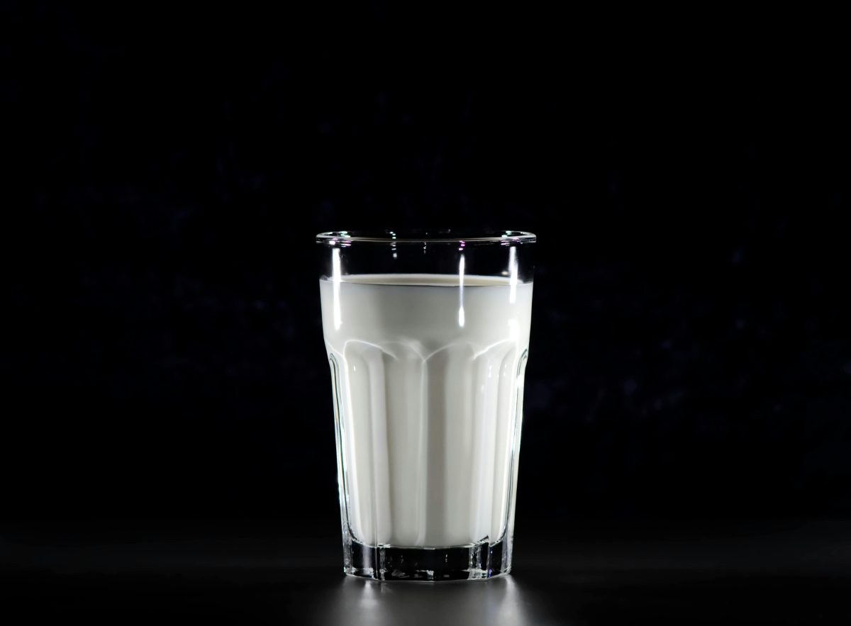 Glass of milk against dark background