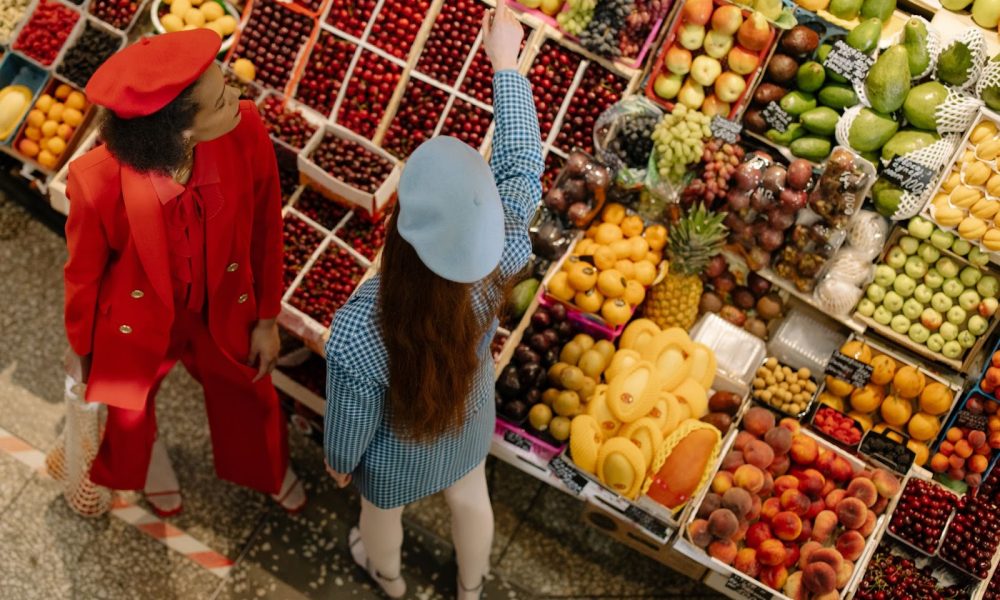 Two women inspecting food at a shop