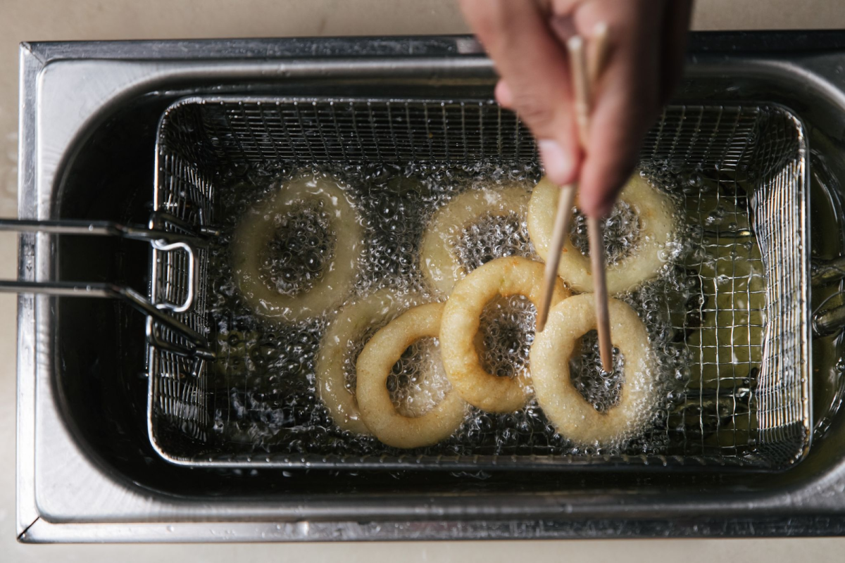 Onion rings being deep-fried
