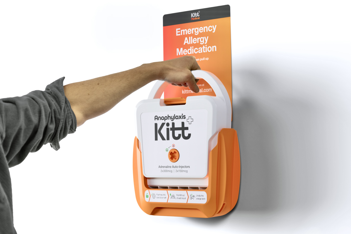 Image of a hand grabbing the Kitt Medical Anaphylaxis Kit from a wall.