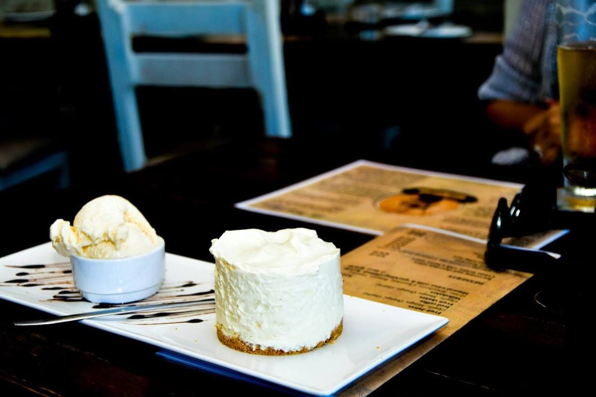 Restaurant table with cheesecake and ice cream dessert