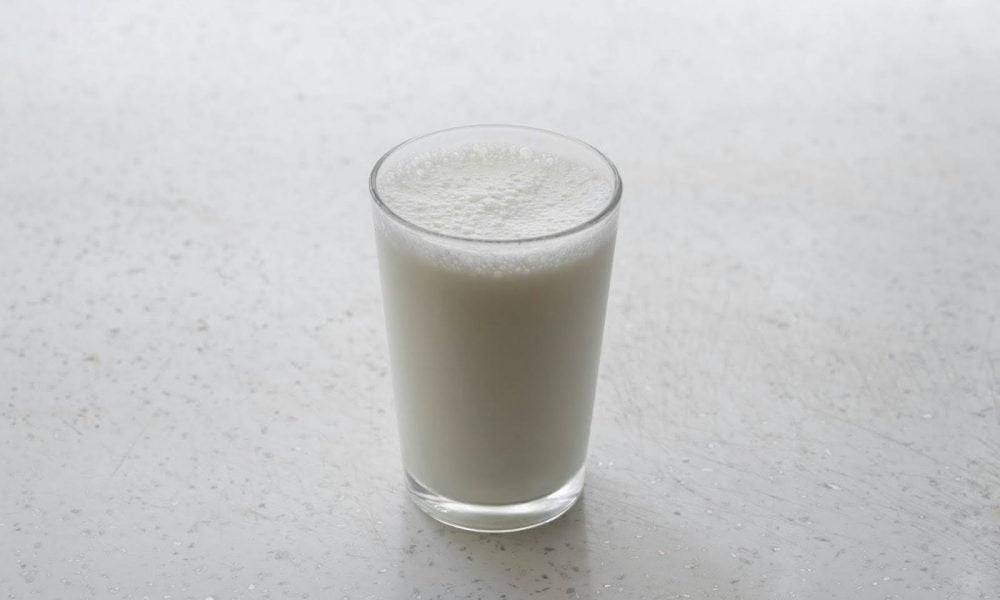 Glass of milk on table